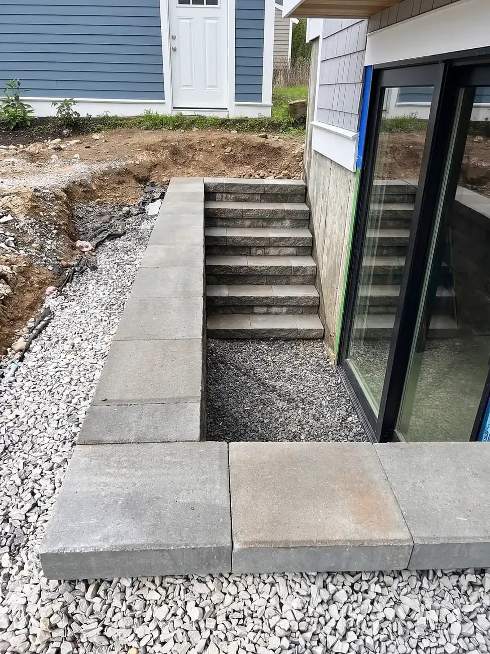 Block retaining wall around new basement egress stairs on a new build