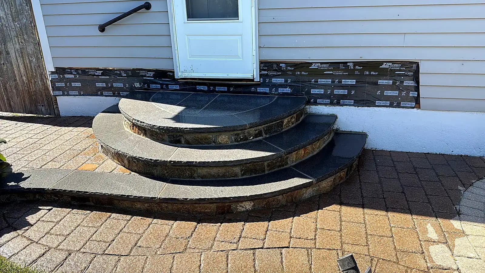 Curved bluestone steps on a paver patio
