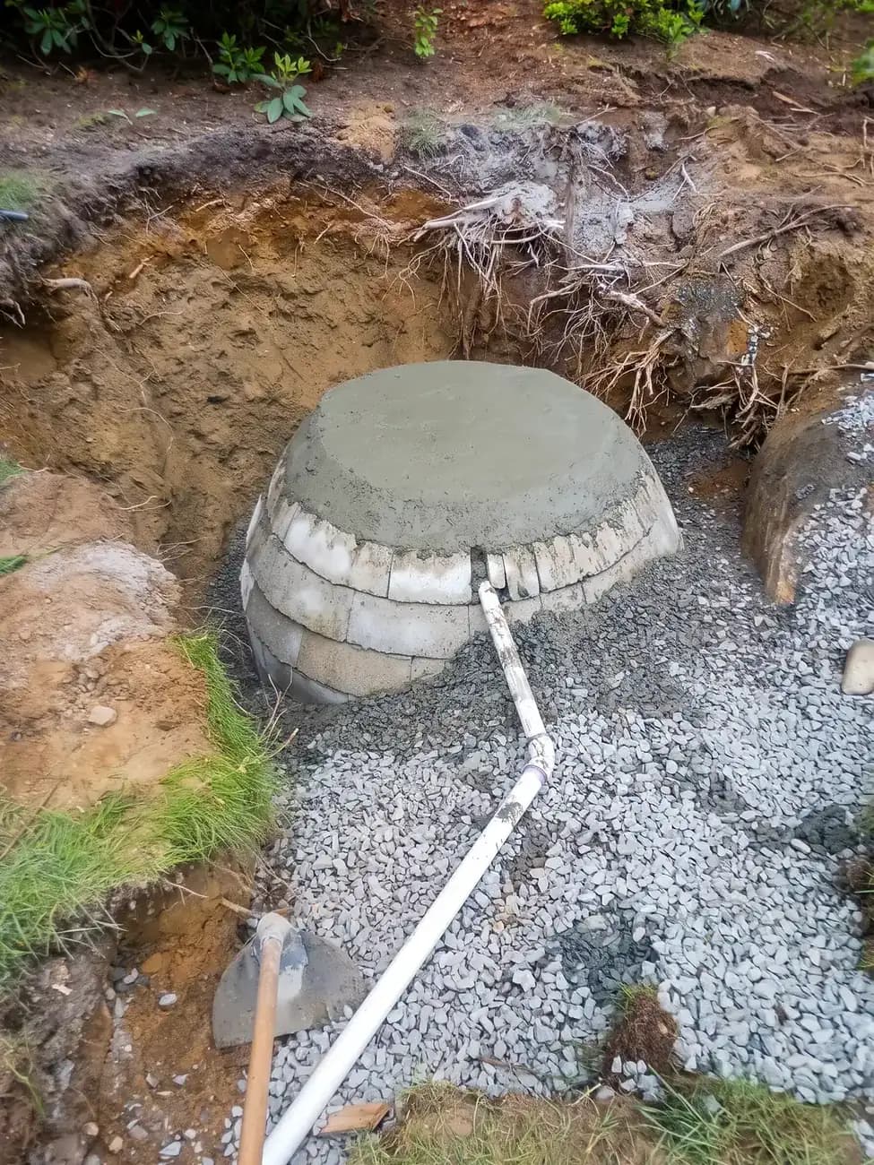 Tie in the pipe and backfill with stone